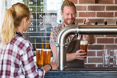 Man pouring beer at bar - AGLC - Price your products